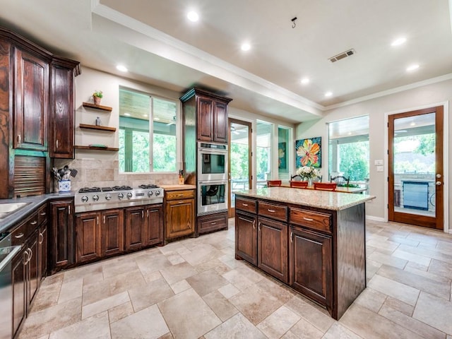 199 Pecan Crossing Ct, Gunter, TX 75058 - kitchen featuring stainless steel appliances, decorative backsplash, ornamental molding, stone tile floors, and recessed lighting