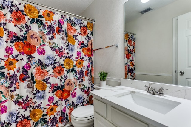 3956 Silver Springs Dr, Fort Worth, TX 76123 - full bathroom with toilet, vanity, a shower with shower curtain, and a textured wall