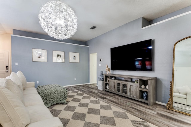 living room featuring an inviting chandelier and hardwood / wood-style floors