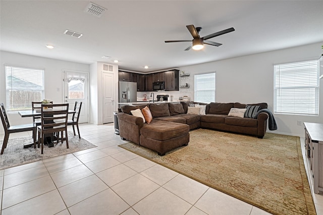 living room featuring light tile patterned flooring and ceiling fan