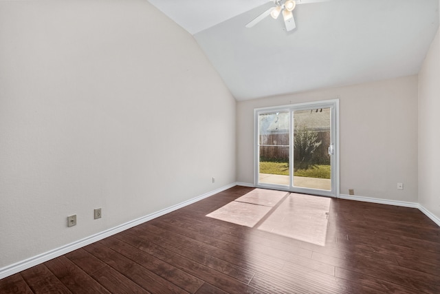 empty room featuring vaulted ceiling, dark hardwood / wood-style floors, and ceiling fan