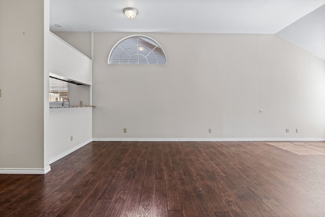 interior space featuring lofted ceiling, sink, and dark wood-type flooring