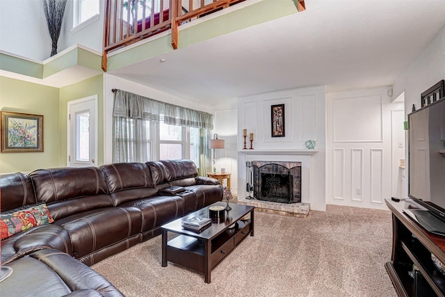 living room with a fireplace and carpet flooring