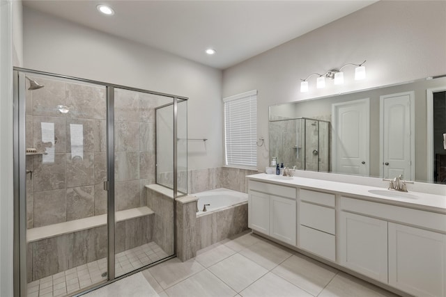 bathroom featuring tile patterned flooring, vanity, and plus walk in shower