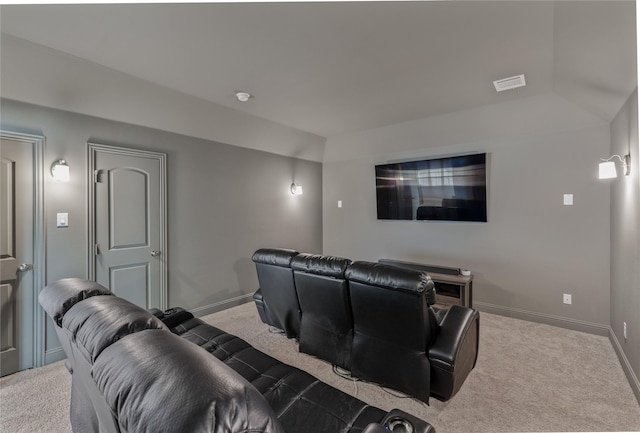 carpeted home theater room featuring vaulted ceiling