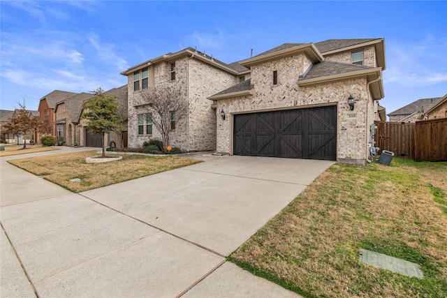 view of front of home with a garage and a front lawn