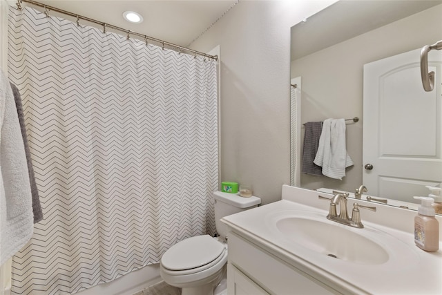 bathroom featuring vanity, toilet, and a shower with shower curtain