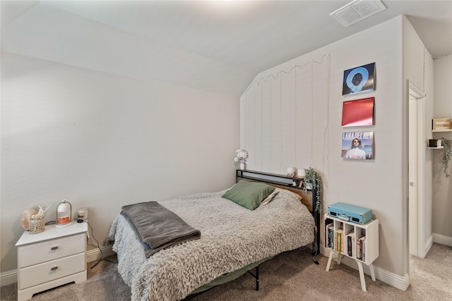 carpeted bedroom with lofted ceiling