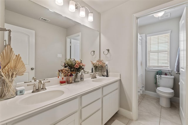 bathroom with tile patterned floors, toilet, and vanity