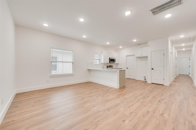 unfurnished living room with light hardwood / wood-style floors