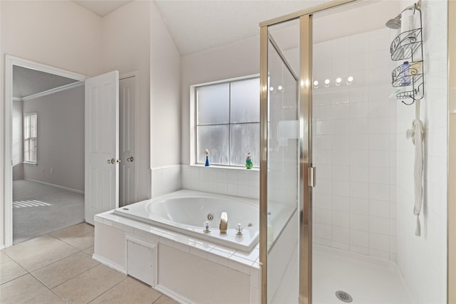 bathroom featuring vaulted ceiling, separate shower and tub, and tile patterned floors