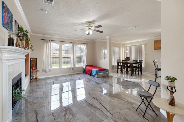 living room featuring ornamental molding and a textured ceiling