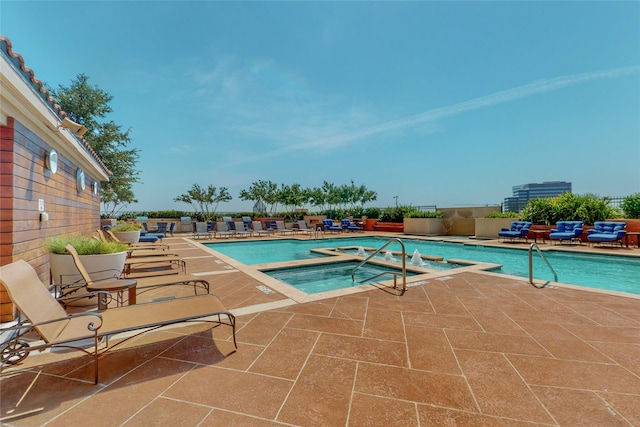 view of swimming pool with a patio and a community hot tub