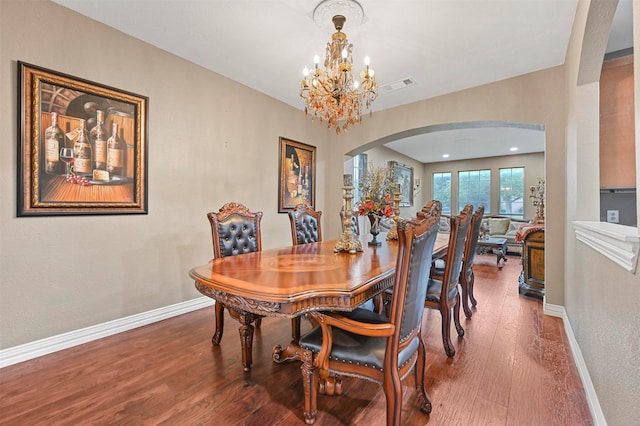 dining area with a notable chandelier and hardwood / wood-style flooring