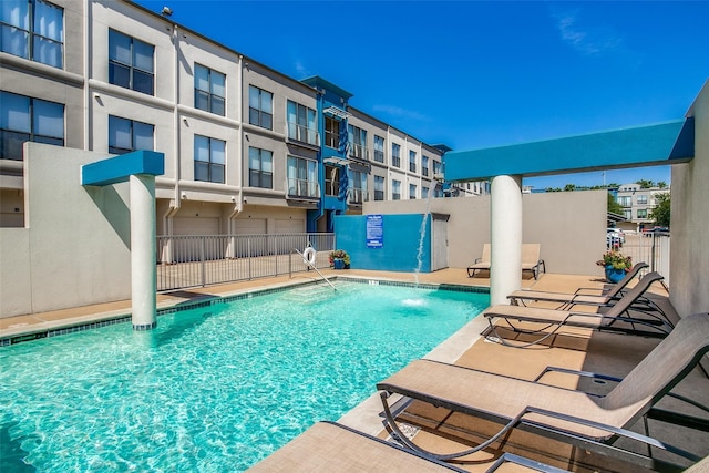 view of pool with pool water feature