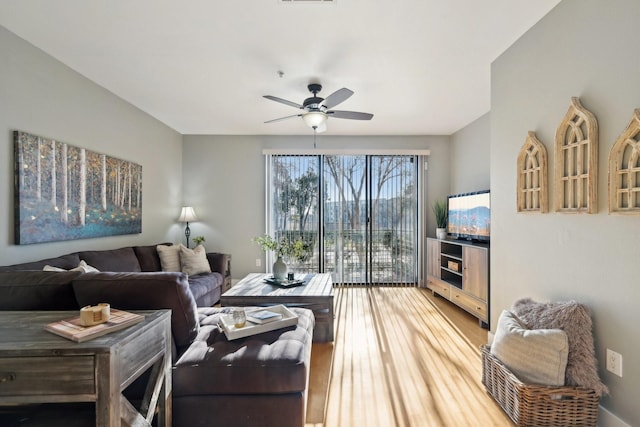 living room with hardwood / wood-style floors and ceiling fan