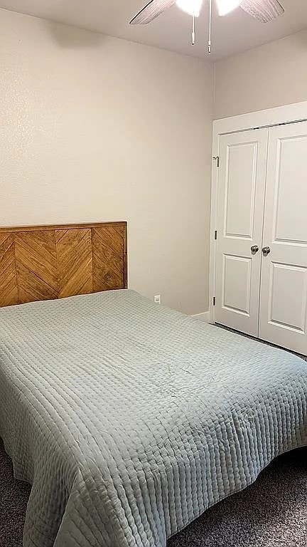 bedroom with ceiling fan and a closet