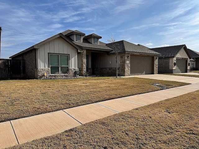 view of front facade with a garage and a front lawn