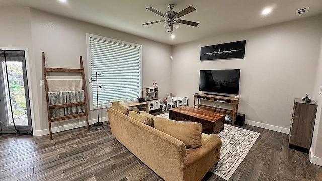 living room featuring dark hardwood / wood-style floors, a wealth of natural light, and ceiling fan