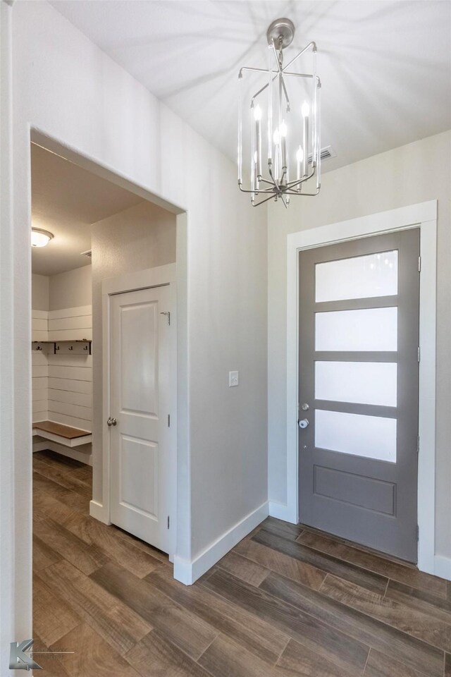 kitchen with appliances with stainless steel finishes, white cabinetry, sink, light stone countertops, and dark wood-type flooring