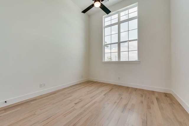 spare room with ceiling fan and light wood-type flooring