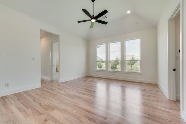 empty room featuring lofted ceiling, light hardwood / wood-style floors, and ceiling fan