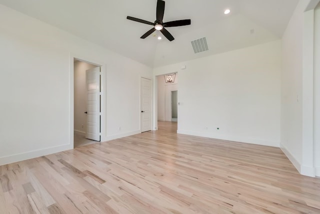 empty room with vaulted ceiling, ceiling fan, and light hardwood / wood-style floors