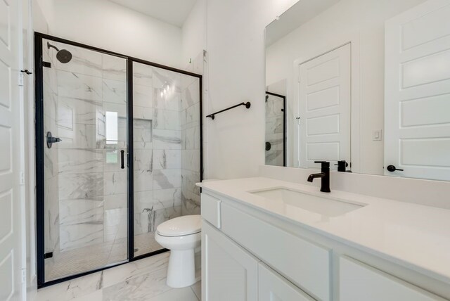 bathroom with vanity, an enclosed shower, and toilet