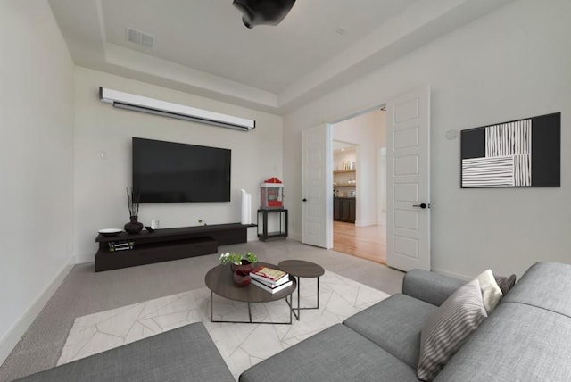 carpeted living room featuring a raised ceiling