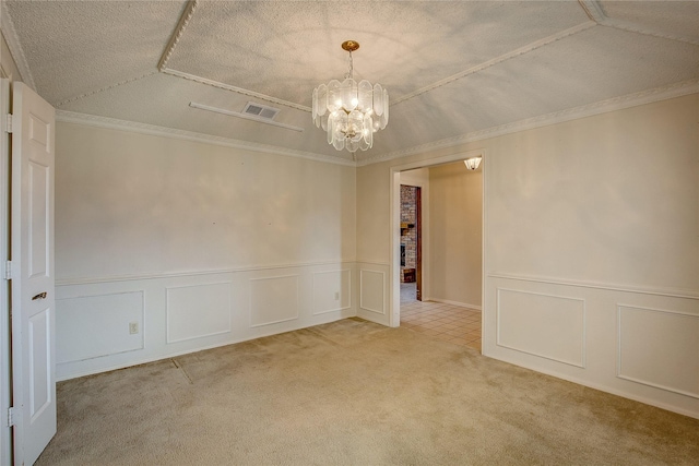 carpeted empty room with an inviting chandelier, crown molding, and a textured ceiling