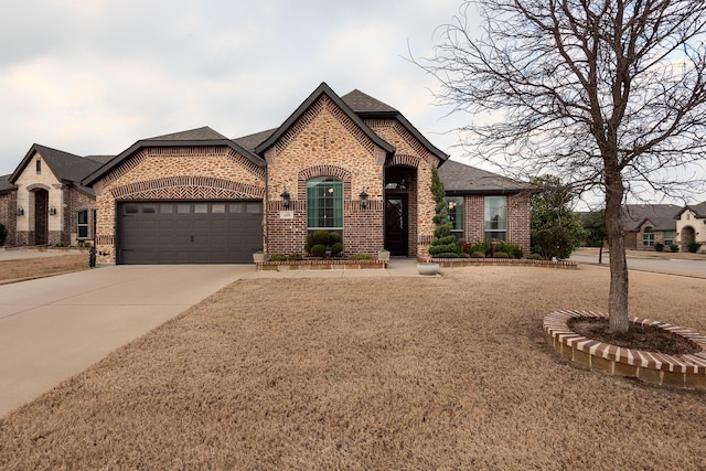 french provincial home with a garage