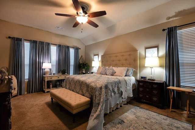 bedroom with ceiling fan, lofted ceiling, and carpet