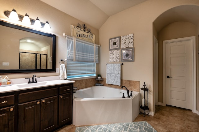 bathroom featuring vanity, lofted ceiling, tile patterned floors, and plus walk in shower