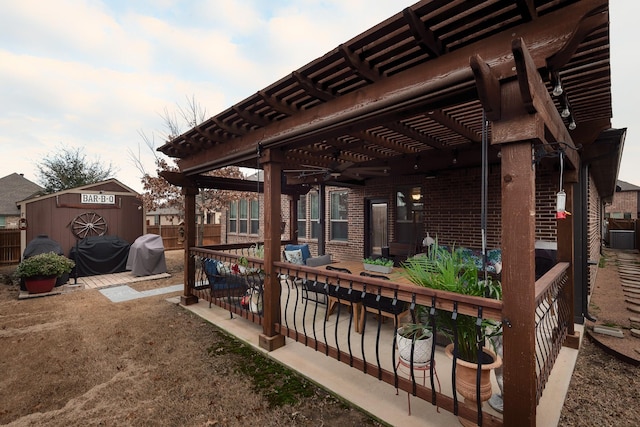 exterior space with a grill, a shed, and a pergola