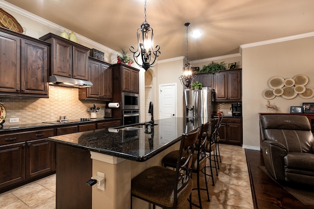 kitchen featuring dark brown cabinetry, pendant lighting, stainless steel appliances, and an island with sink