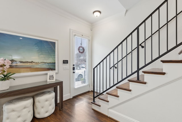 foyer featuring dark wood-type flooring and ornamental molding