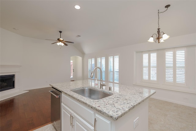 kitchen with white cabinetry, dishwasher, sink, hanging light fixtures, and a center island with sink