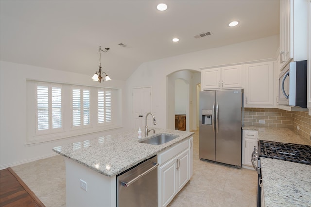 kitchen with white cabinetry, appliances with stainless steel finishes, sink, and a kitchen island with sink