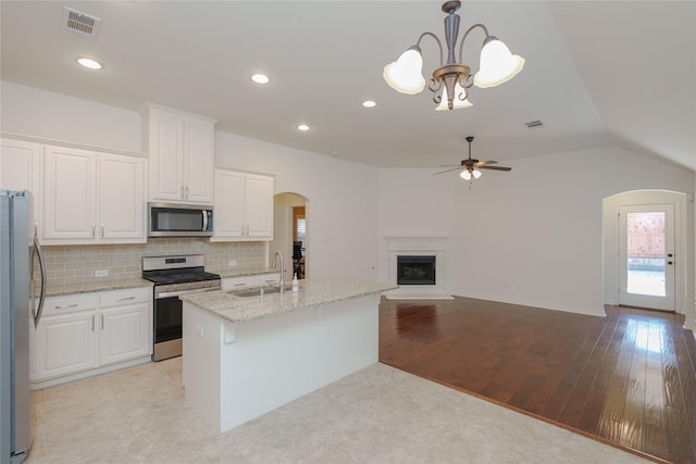 kitchen featuring white cabinetry, appliances with stainless steel finishes, sink, and pendant lighting