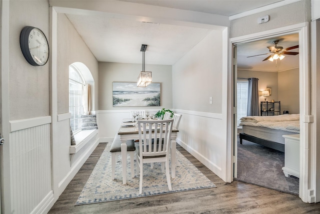 7502 Atlantic Dr, Rowlett, TX 75088 - dining space featuring dark wood-type flooring, a wainscoted wall, a ceiling fan, and a chandelier