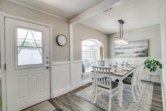 7502 Atlantic Dr, Rowlett, TX 75088 - dining room with wood finished floors, healthy amount of natural light, a wainscoted wall, a chandelier, and ornamental molding