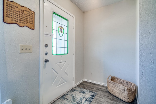 doorway to outside featuring hardwood / wood-style flooring and a textured ceiling