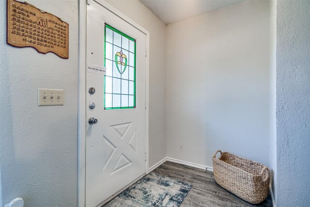 7502 Atlantic Dr, Rowlett, TX 75088 - entryway featuring wood finished floors and baseboards