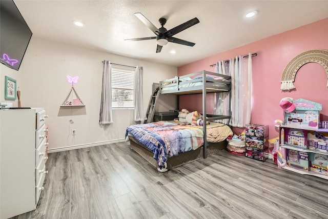 bedroom featuring ceiling fan, baseboards, wood finished floors, and recessed lighting