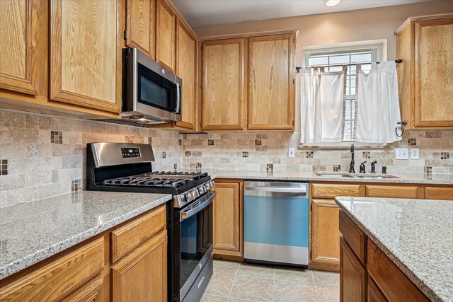 kitchen with a kitchen island, decorative backsplash, light tile patterned floors, light stone countertops, and white appliances