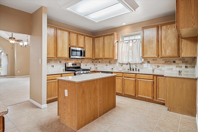 clothes washing area with washing machine and dryer and light tile patterned floors