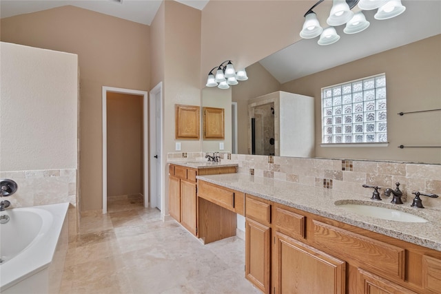 bathroom with tasteful backsplash, separate shower and tub, vaulted ceiling, vanity, and a notable chandelier