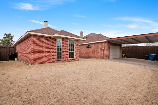 back of property with a carport and a garage