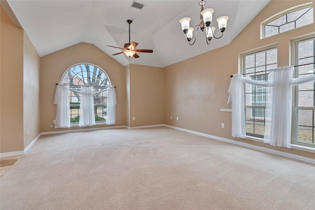 empty room featuring ceiling fan with notable chandelier, vaulted ceiling, and light carpet