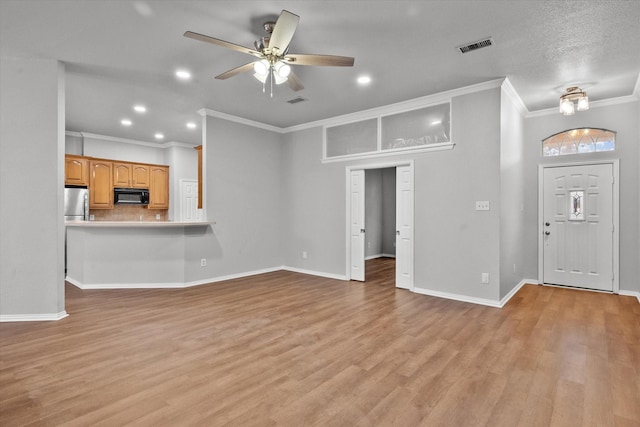 unfurnished living room featuring crown molding, ceiling fan, and light hardwood / wood-style floors